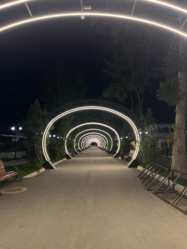 Illuminated arch pathway lights up Kadamjay at night