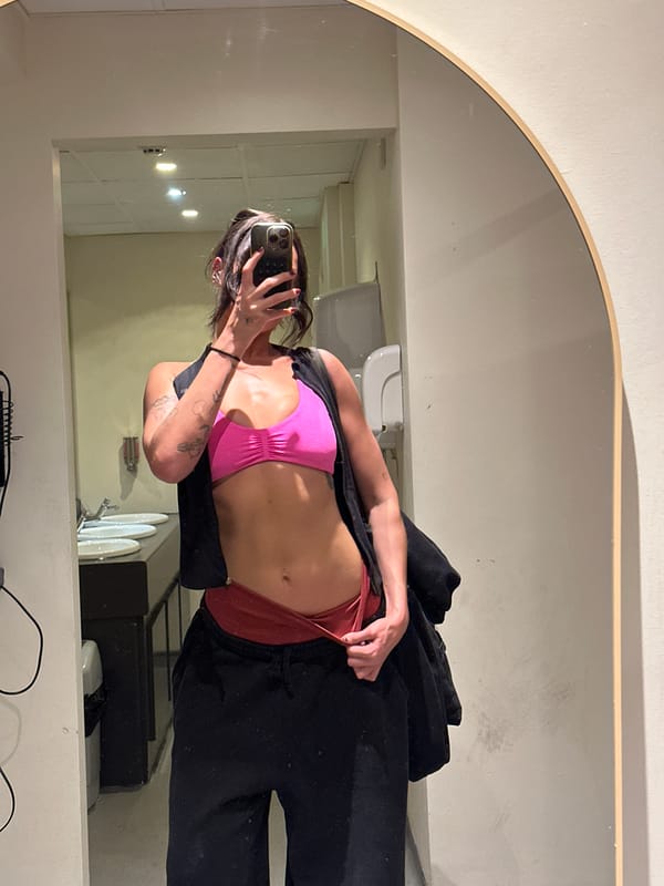 Woman takes mirror selfie in athletic wear, Tunbridge Wells