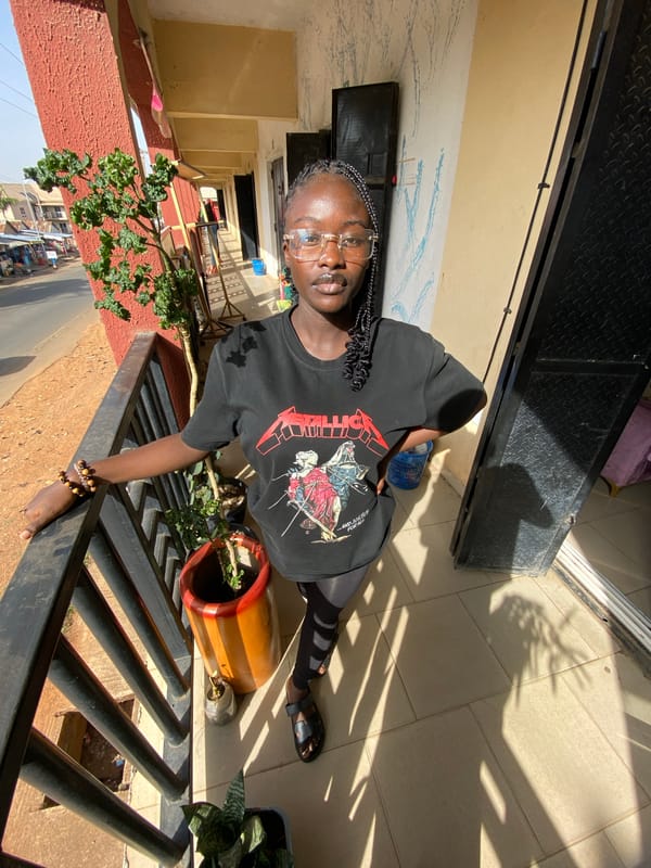 Woman in Metallica shirt captured in everyday moments in Bukuru