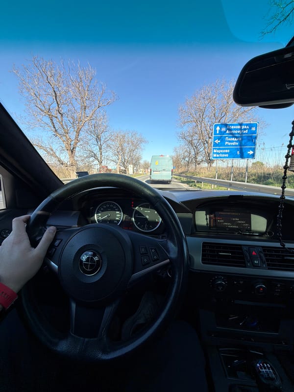 Motorist travels road approaching Plovdiv, Bulgaria under clear skies