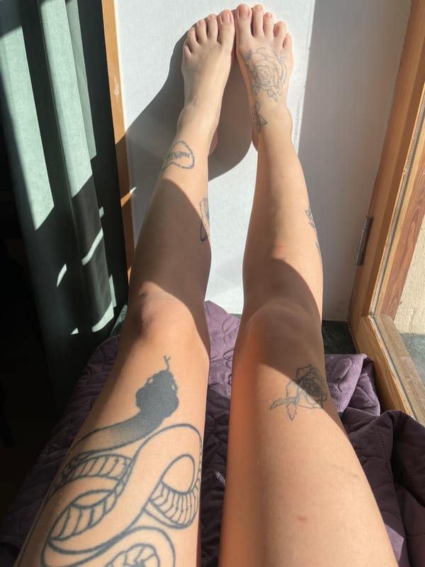 Tattooed woman photographed indoors in early morning Tbilisi