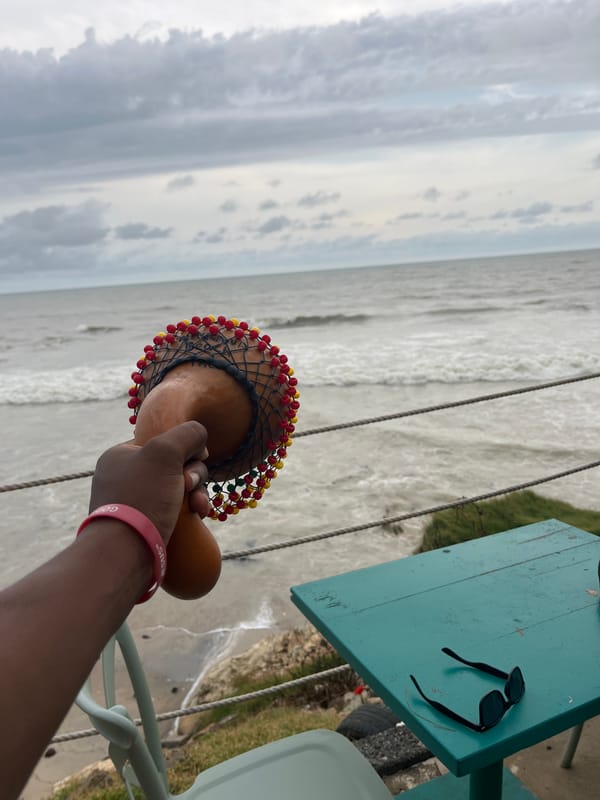 Traditional musicians perform beachside dance routine in stormy Accra