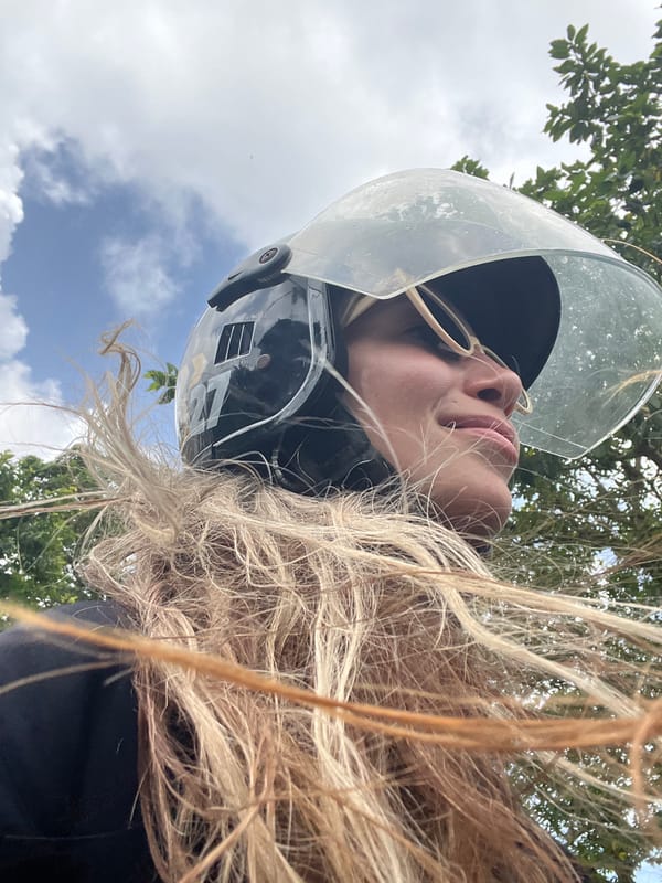 Helmeted rider caught in the wind near Weligama coast