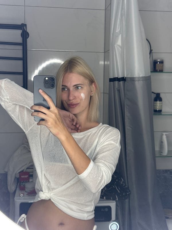 Woman documents morning skincare routine in Saratov bathroom selfies