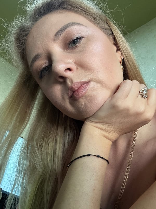 Indoor selfie session with red top and gold jewelry