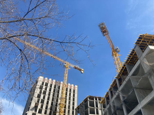 Construction cranes active at building site in Perm