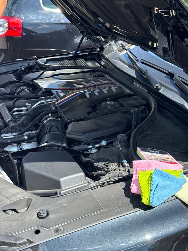 Man details BMW engine bay in Targovishte, Bulgaria