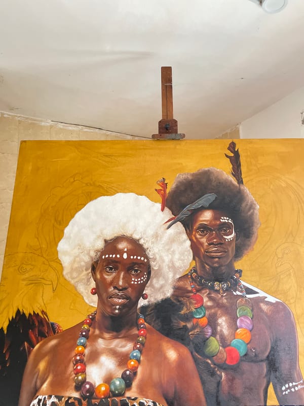 Artist paints traditional Nigerian figures with tribal markings in Ado