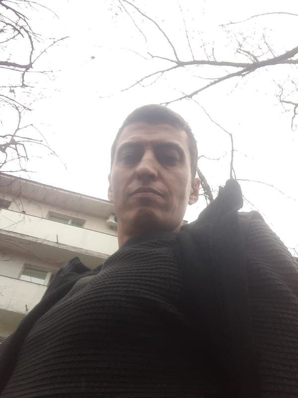 Man takes selfie while dog rests in Sofia park