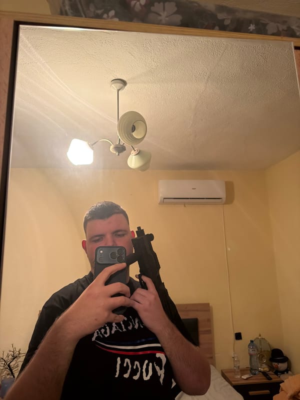 Person takes mirror selfie while holding firearm in Bulgaria