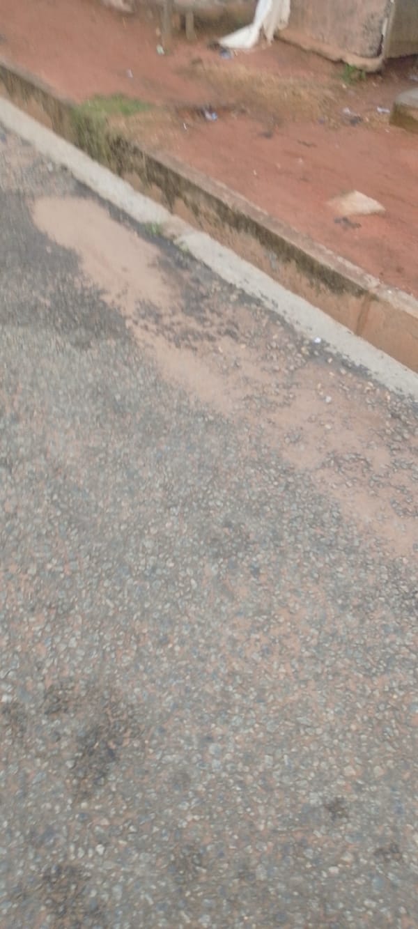 Tuk-tuks navigate a potholed urban road