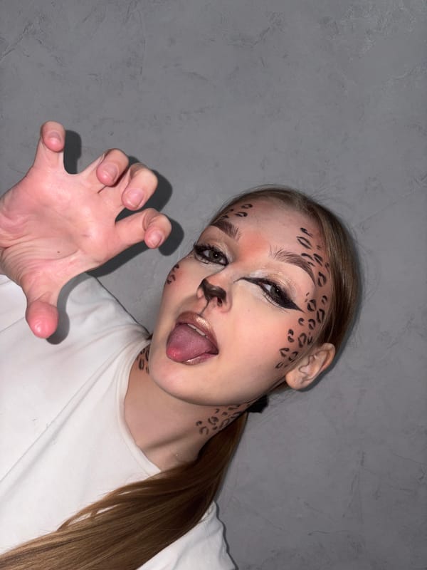 Woman sports cheetah face paint in Chaikovsky selfie session