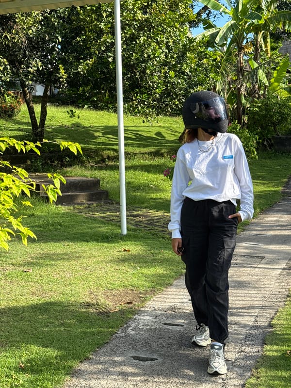 Motorcyclist stops in garden setting in Buduk, Indonesia