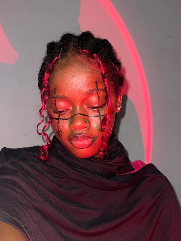 Portrait session with dramatic red lighting captured in Ado