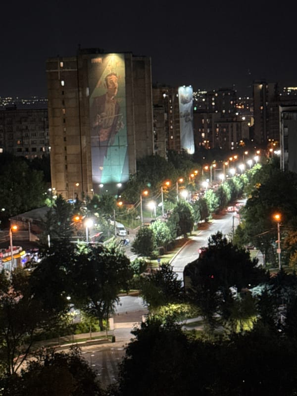 Night views over a mural-marked residential street in Tbilisi
