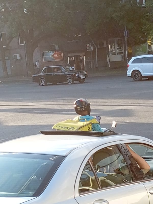 Yandex.Go delivery scooter navigates Yerevan streets midday