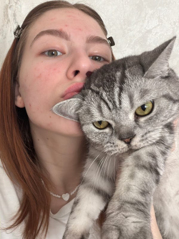 Woman and gray tabby cat share quiet morning moments