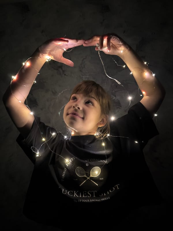 Children play with string lights indoors in Russia