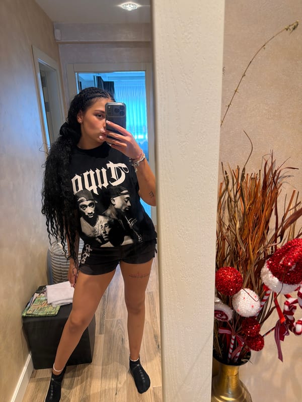 Mirror selfie in Gabrovo hallway, hip-hop graphic tee front and center