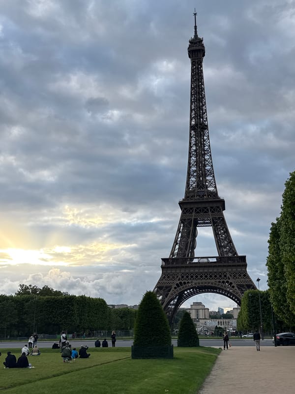Eiffel Tower photographed against cloudy Paris sky