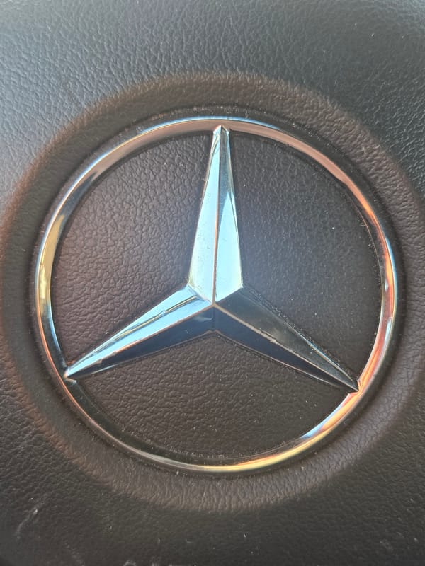 Mercedes-Benz logo captured on vehicle steering wheel
