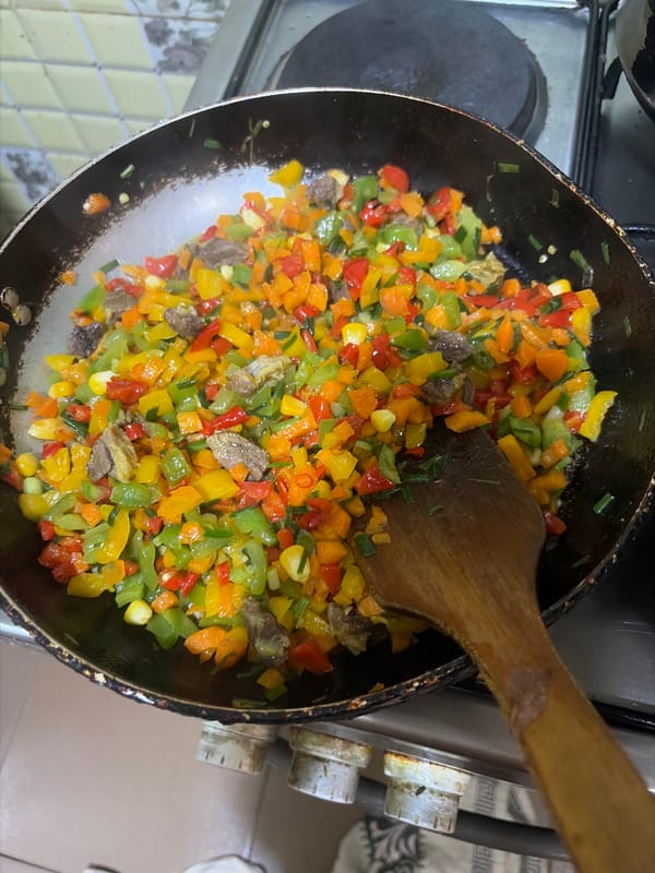 Home cook prepares colorful bell pepper and rice meal
