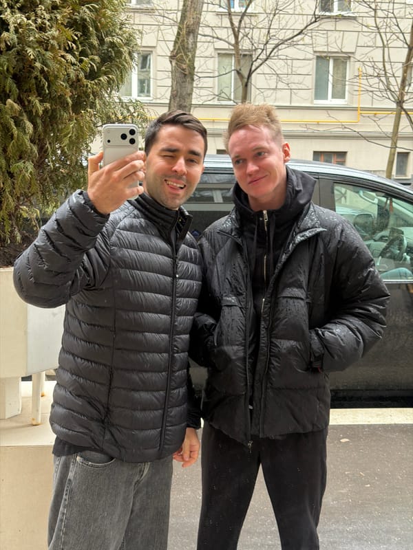 Two men take smiling selfie outdoors in Moscow