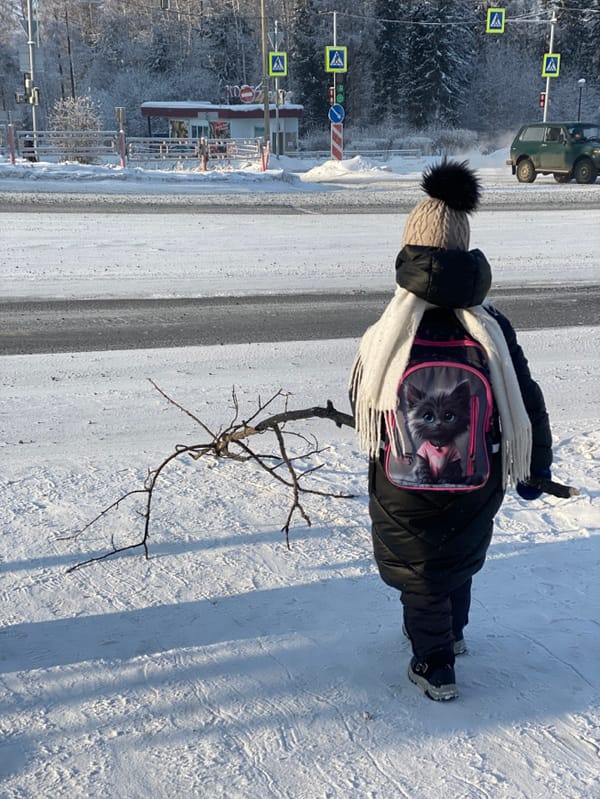 Person in winter gear observed on snowy road in Ust-Ilimsk