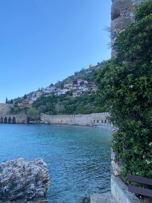 Tourist photographs Alanya's historic fortifications and Mediterranean coastline