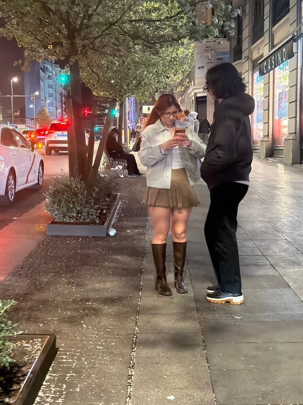Two people stand outside Madrid casino early morning