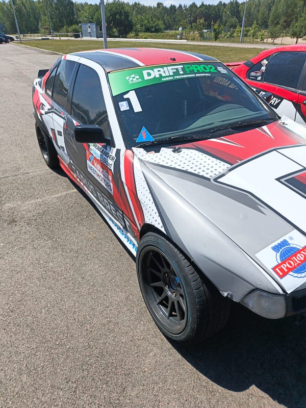 Race car livery detail, white and red with sponsor graphics