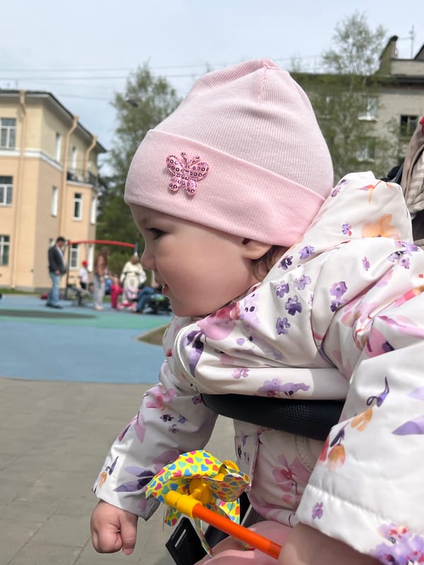 Child plays with toys during park outing in Shushary