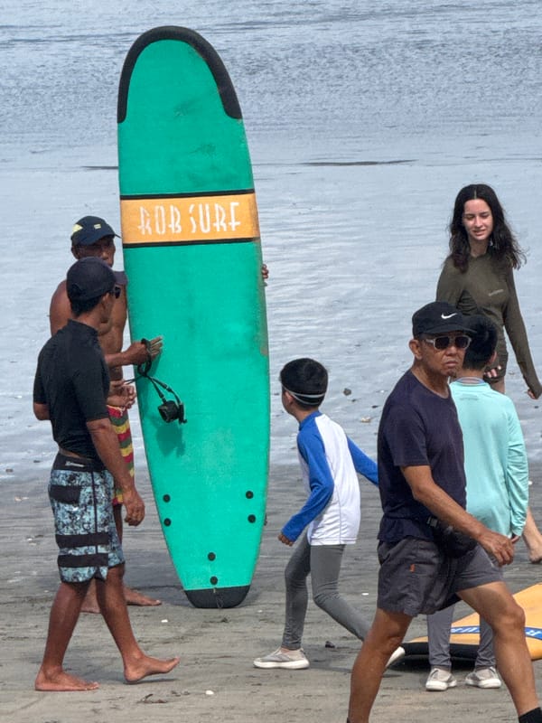Surf lessons and beach activity along Kuta's shoreline