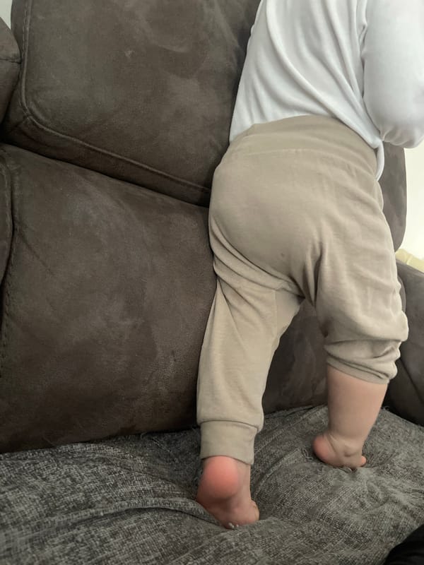 Baby rests on couch in Portslade by Sea home