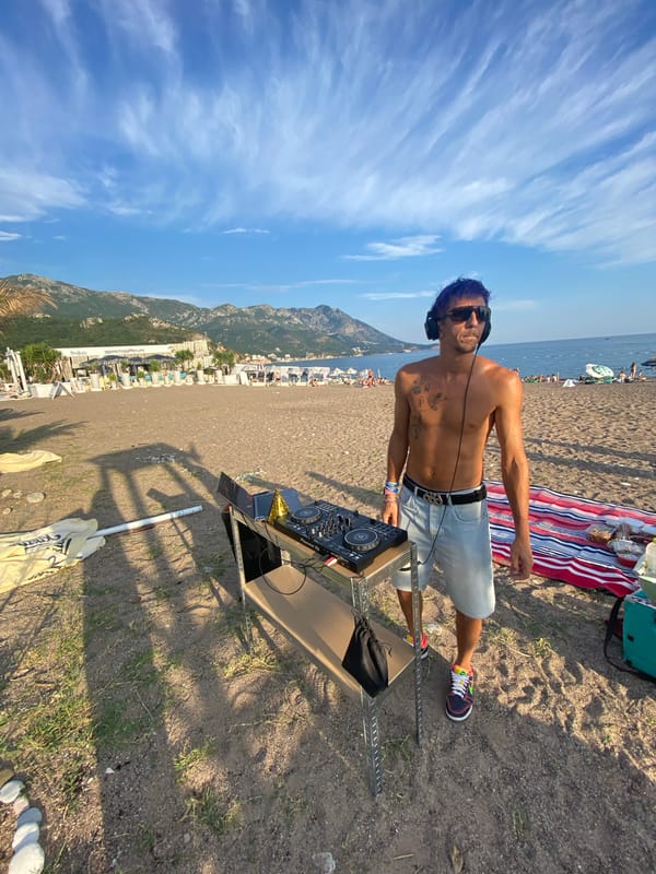 Beach day mix of DJ setup, volleyball, and a picnic