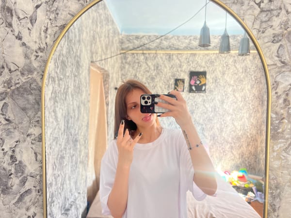 Woman takes morning selfies in bedroom in Moldova
