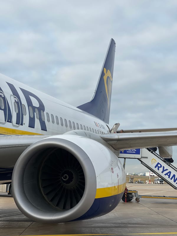 Ryanair flight boards passengers at Valencia Airport under cloudy skies