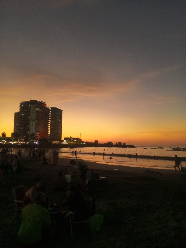 Sunset Beach Gathering Observed in Iquique, Chile with Helicopter Overhead
