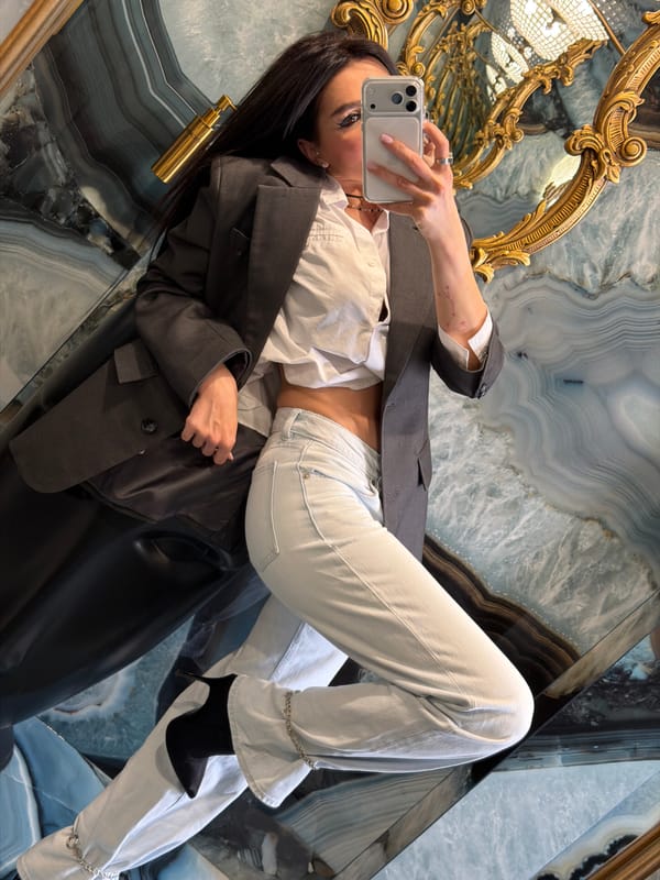 Woman takes selfies at ornate mirror in Moscow interior