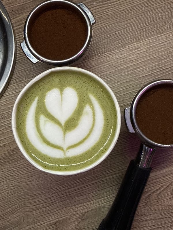 Green matcha latte prepared at Moscow coffee station
