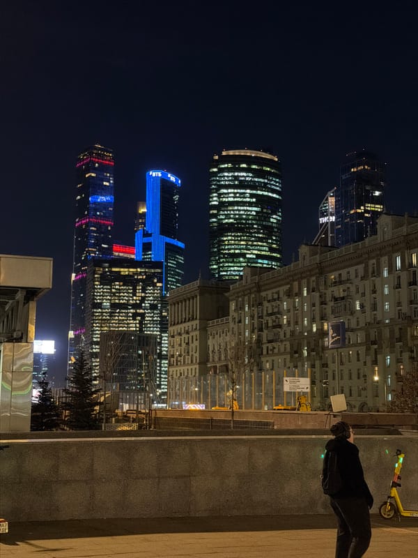 Moscow skyscrapers illuminate night sky with colorful architectural lighting