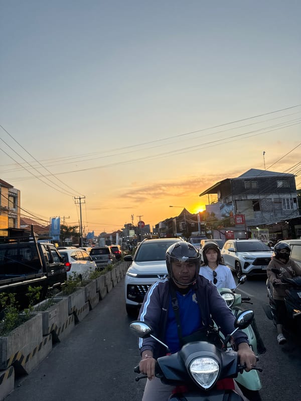 Rush hour traffic builds on a Denpasar street at sunset
