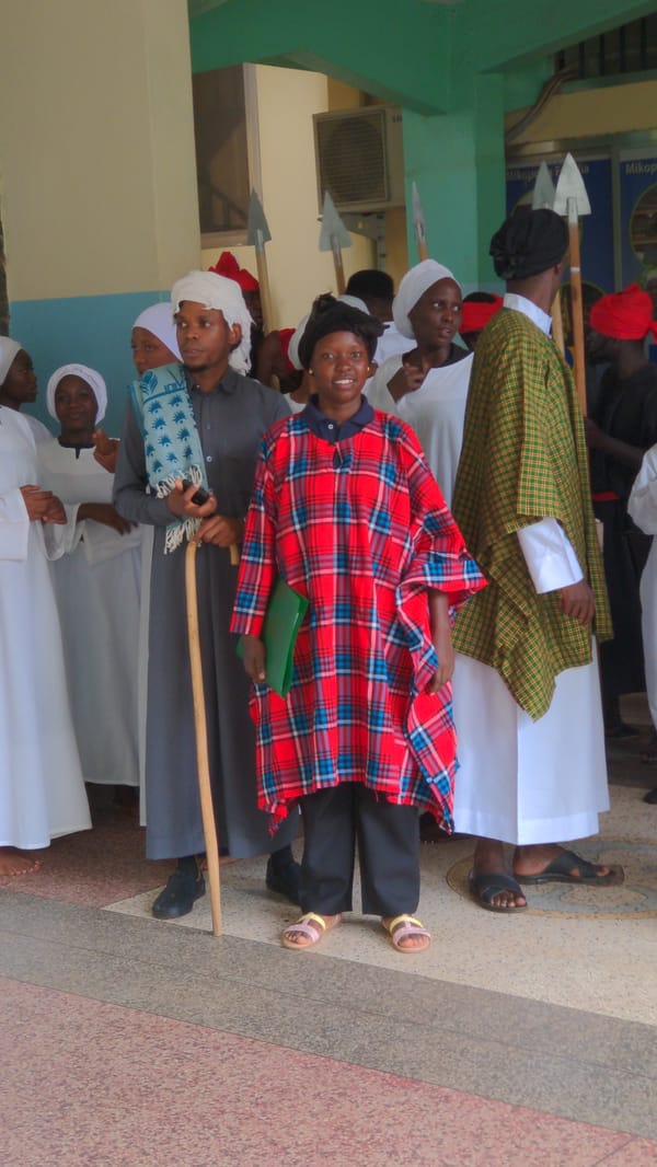 People queue indoors in Moshi, Tanzania hall