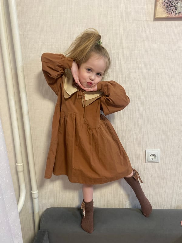 Child photographed in various outfits at Izhevsk home