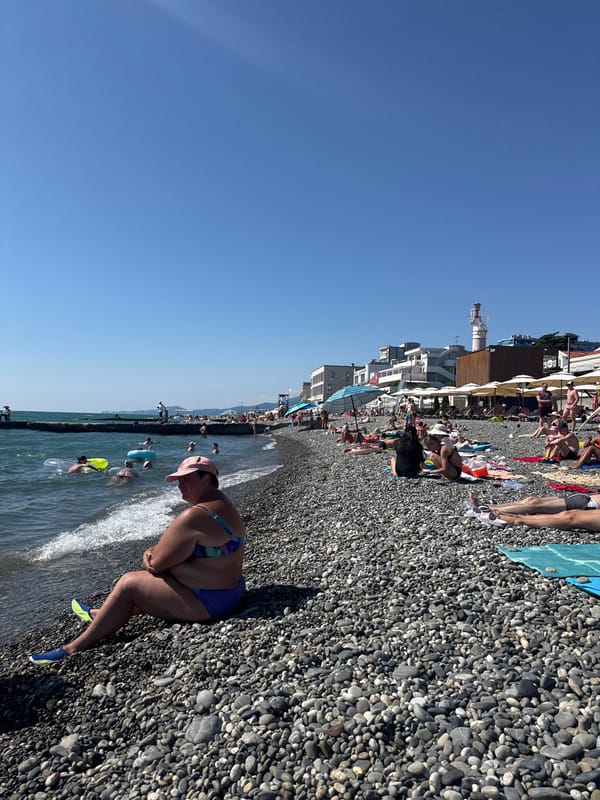 Crowded summer day on Sochi's Black Sea pebble beach