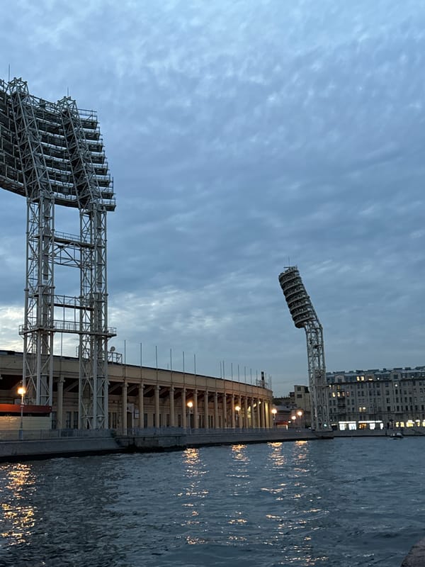 Petrovsky Stadium seen from the river, motorboat passing by