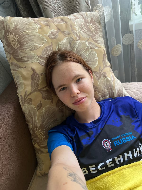 Late-night home routine: couch, cat, and skincare in Chaikovsky