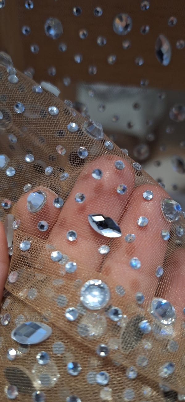 Person examines rhinestone fabric in Blagoevgrad, Bulgaria