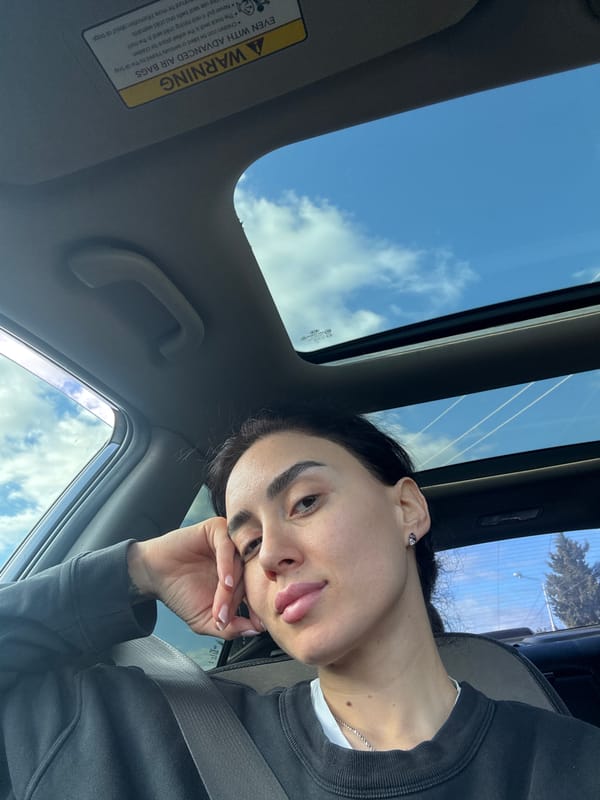 Woman rests in car with sunroof in Tbilisi