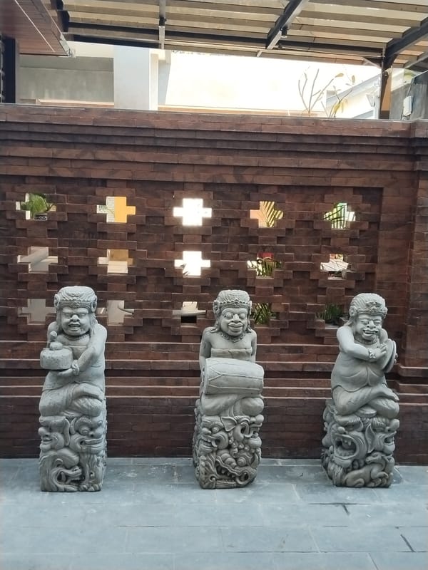 Balinese stone sculptures and koi ponds at a Kuta venue